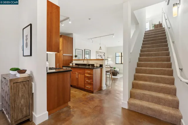 a view of kitchen with sink and refrigerator