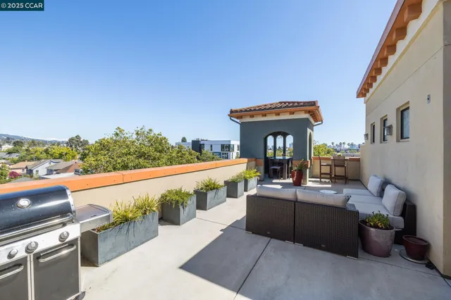 a view of a balcony with couches and wooden floor