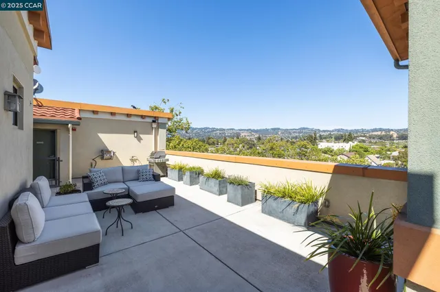 a view of balcony with furniture and city view
