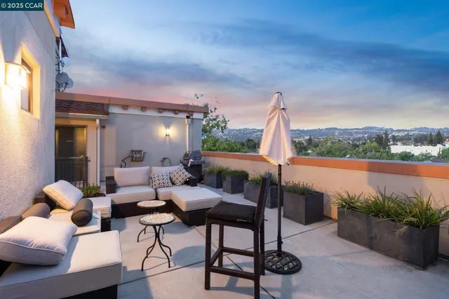 a view of a patio with couches table and chairs and potted plants