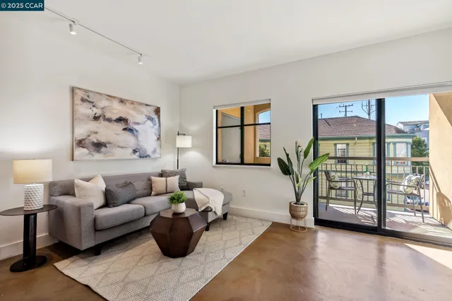 a living room with furniture and a window with balcony view