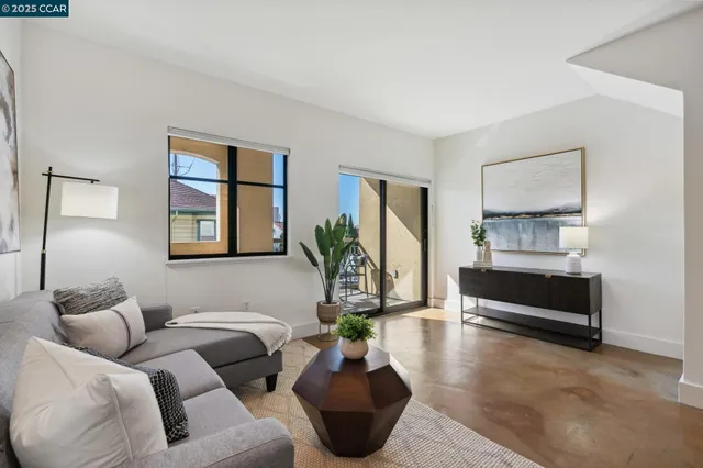 a living room with furniture and a potted plant