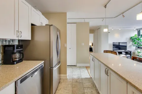 a kitchen with a refrigerator and a sink