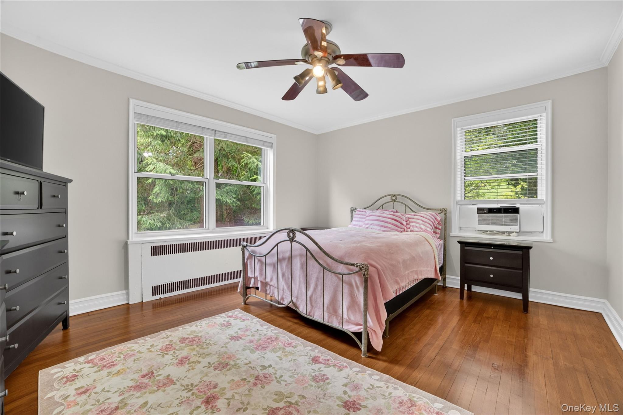 824 Palmer Road, Unit 1F Bronxville, NY 10708 - Photo 14 of 26 a bedroom with a bed and a dresser next to a window