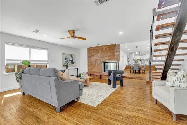 a view of empty room with wooden floor and fireplace