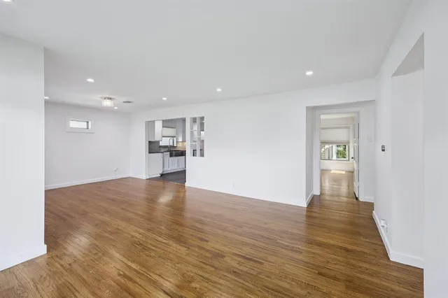 a view of kitchen with refrigerator stove and wooden floor