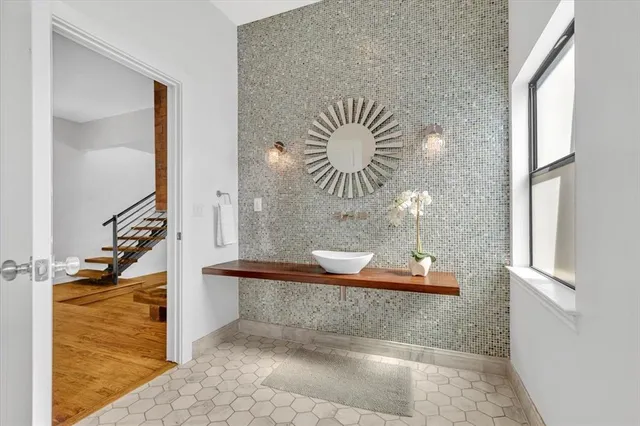 a bathroom with a toilet a sink and a mirror