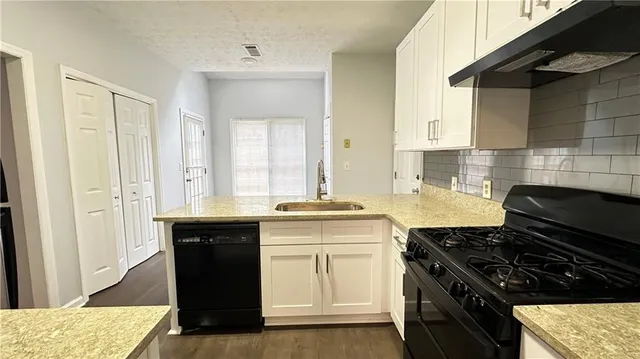 a kitchen with a stove and a sink