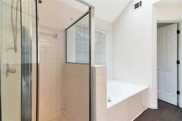 a bathroom with a bathtub and shower
