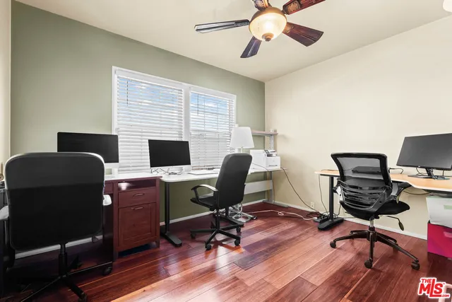 a view of a workspace with furniture and a window