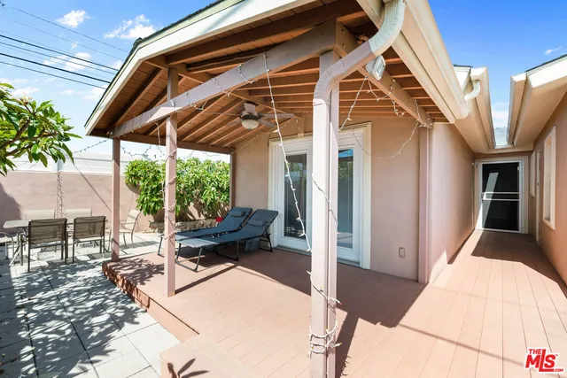 a building outdoor space with patio furniture and potted plants