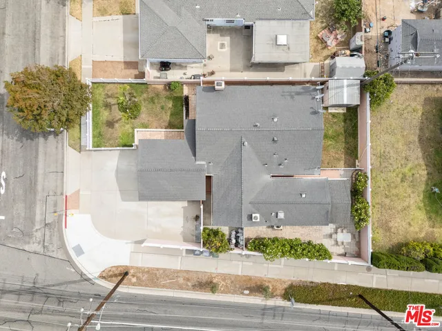 a aerial view of a brick building next to a yard
