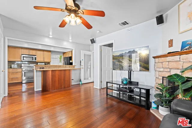 a living room with furniture and kitchen view