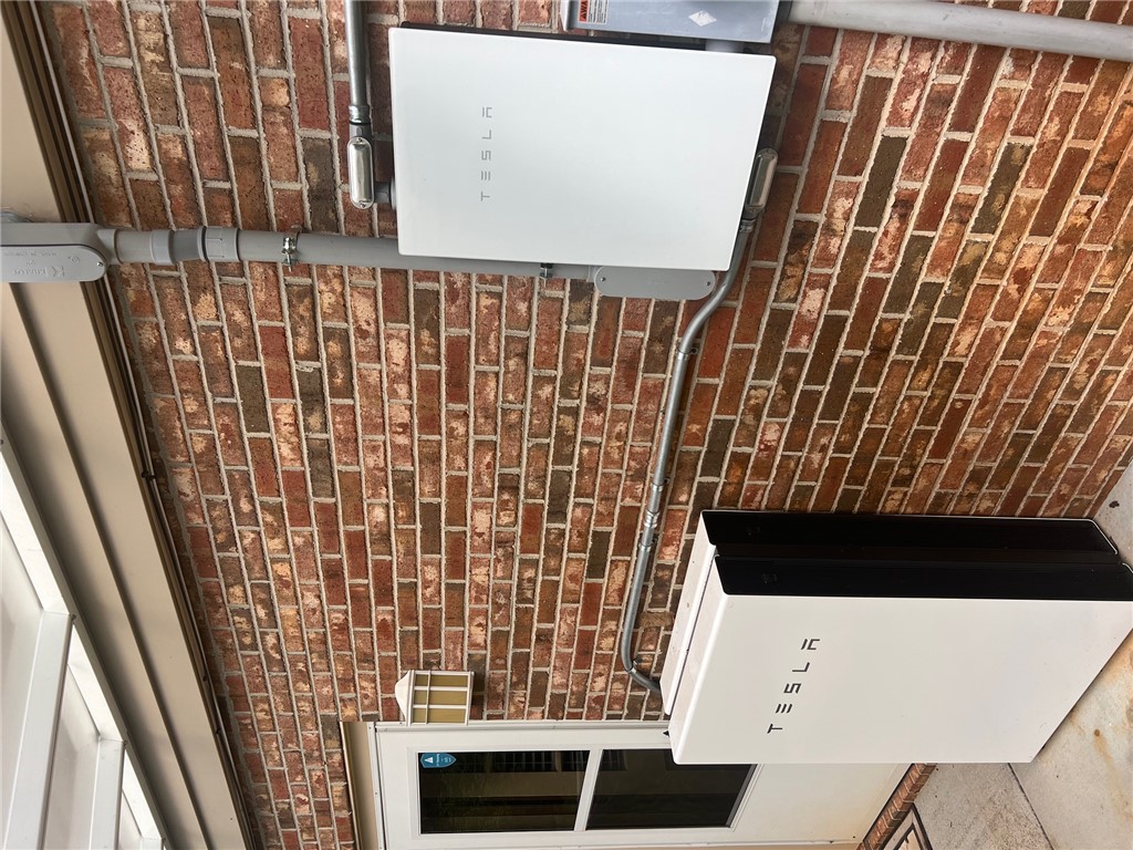 1002 Berkeley Drive Clemson, SC 29631 - Photo 24 of 25 A modern home backup energy system is mounted securely on a classic brick exterior wall.