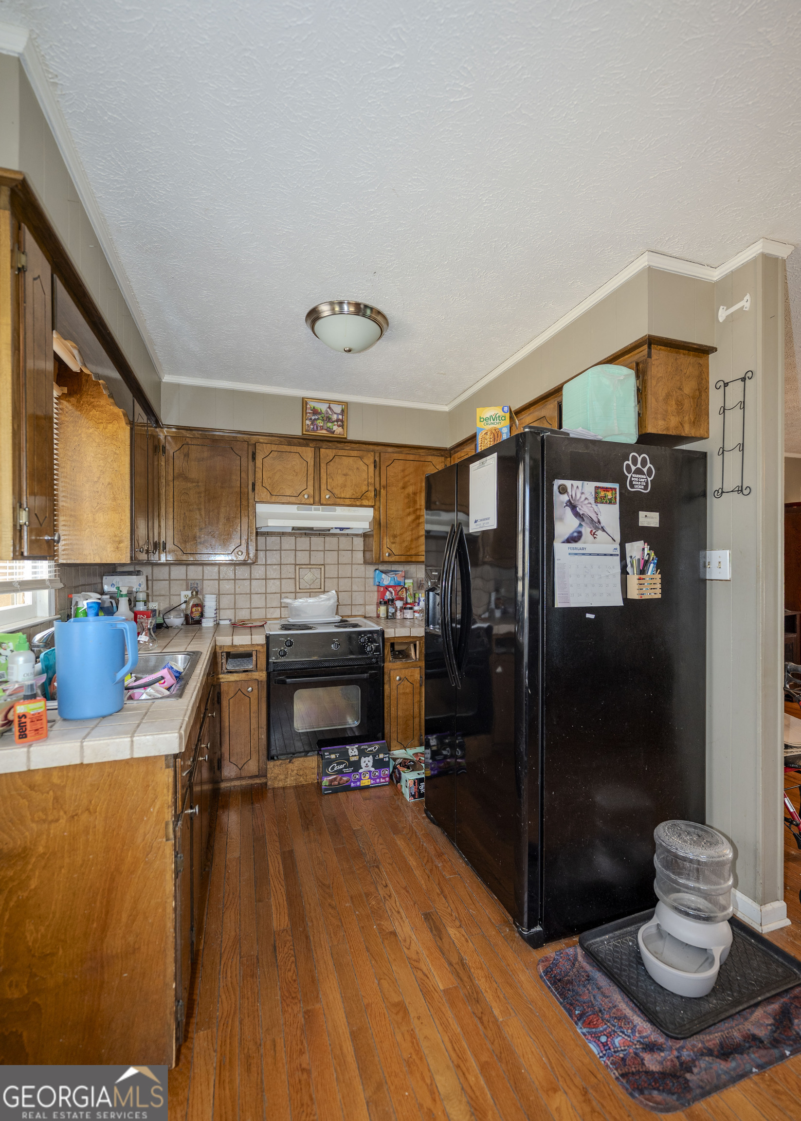 213 Ricefield Road Hartwell, GA 30643 - Photo 7 of 18 a living room with furniture a rug and a refrigerator