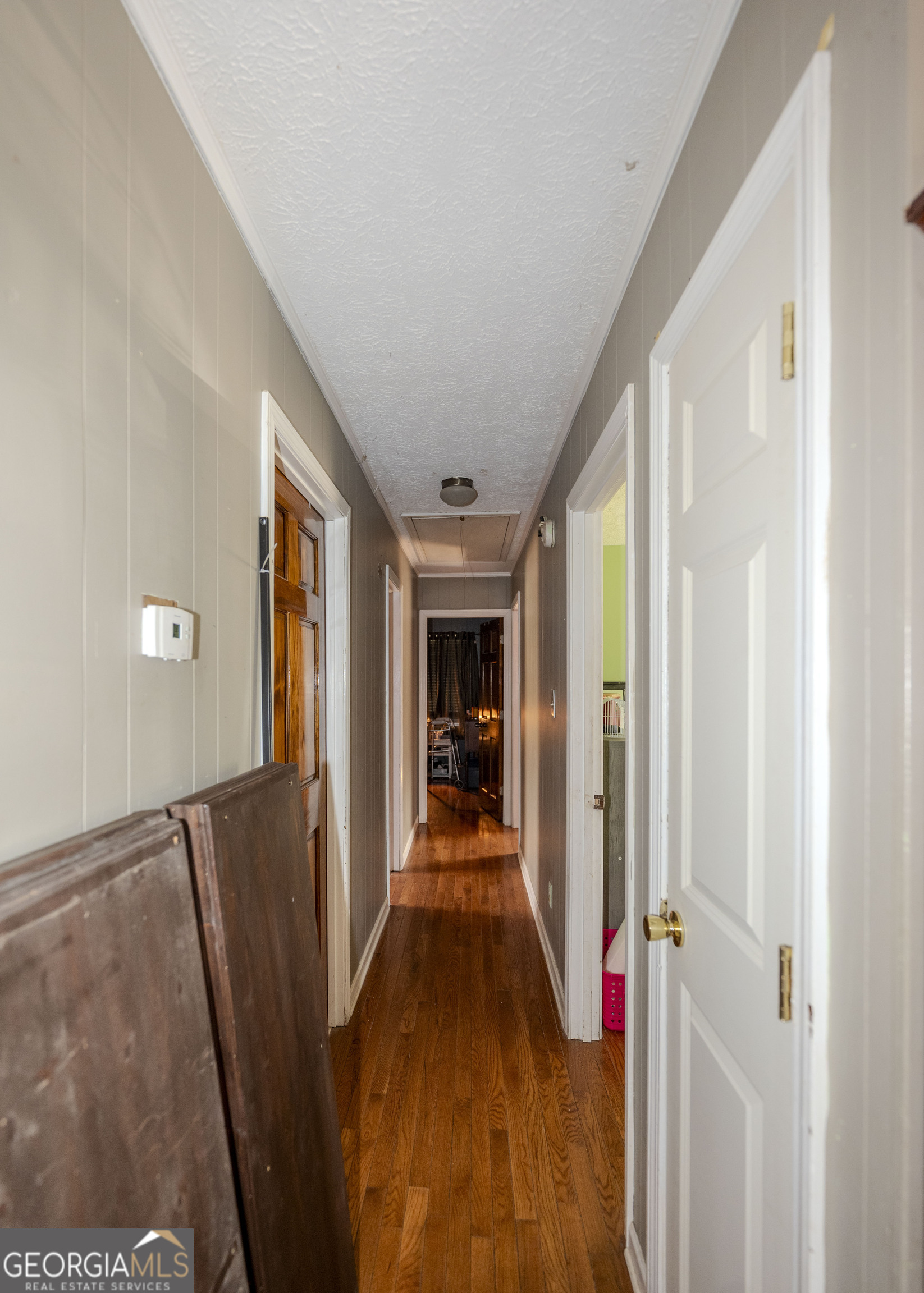 213 Ricefield Road Hartwell, GA 30643 - Photo 8 of 18 a view of a hallway to a livingroom with wooden floor and furniture