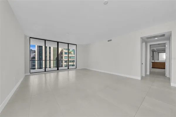 a kitchen with stainless steel appliances a sink a stove a refrigerator and cabinets