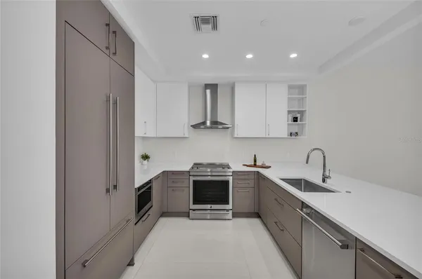 a kitchen with stainless steel appliances a sink and cabinets