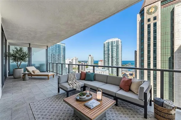 a balcony with furniture and a potted plant