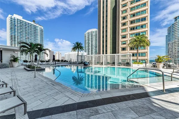 a very nice looking room with many windows and furniture