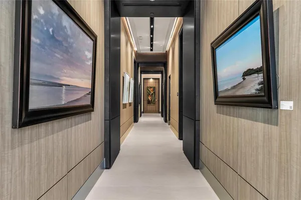 a view of a hallway with wooden floor and door