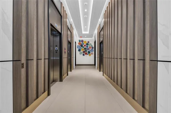 a view of a hallway with wooden floor and entryway