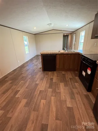 a view of kitchen with cabinets and wooden floor