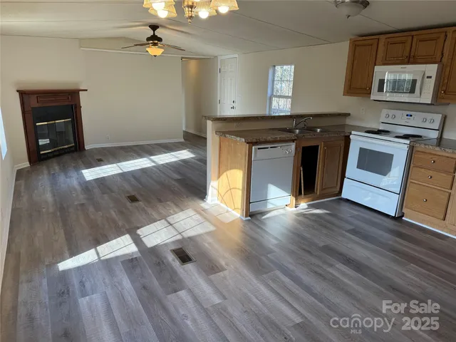 a view of a kitchen with wooden floor and electronic appliances