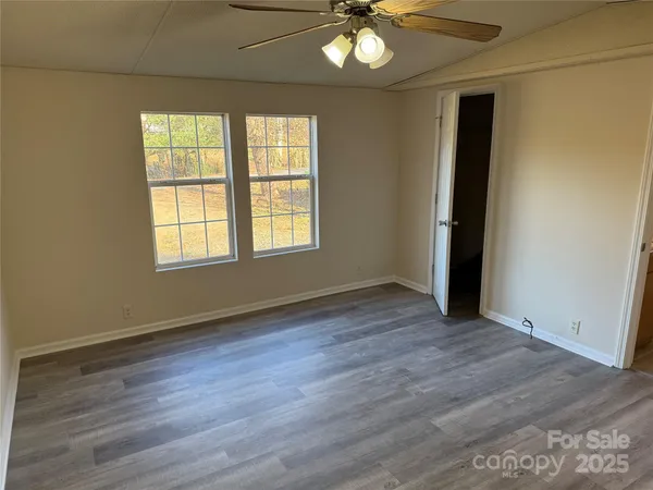 a view of a roof deck with wooden fence and wooden floor