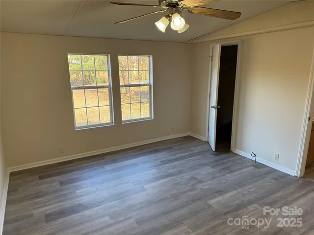 a view of a roof deck with wooden fence and wooden floor