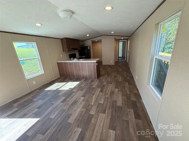 a view of a room with wooden floor and a window