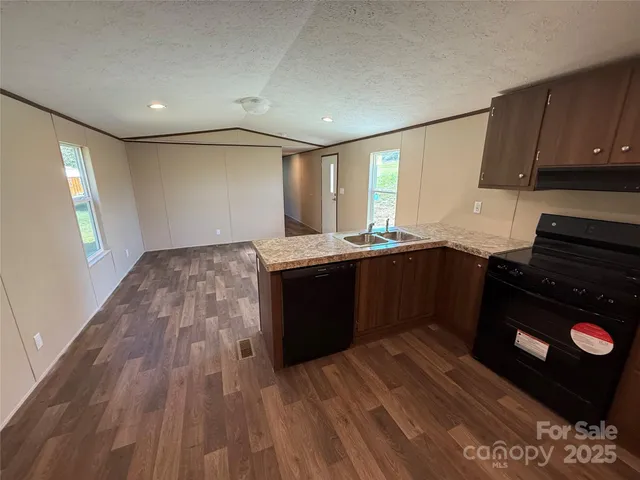a kitchen with a sink and a stove top oven