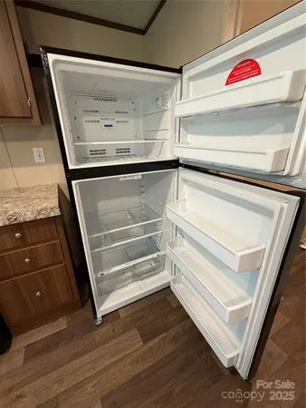 a view of walk in closet with an empty room