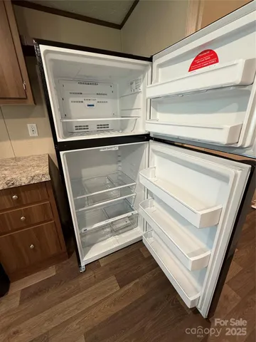a view of walk in closet with an empty room