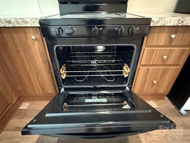 a stove top oven sitting inside of a kitchen