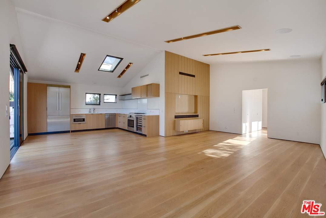 a view of empty room with wooden floor