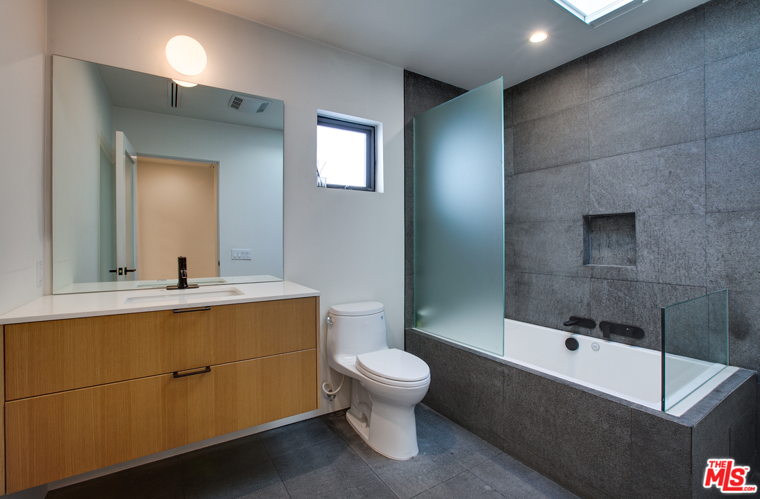 800 7th Avenue Venice, CA 90291 - Photo 19 of 28 a bathroom with a sink a toilet and mirror