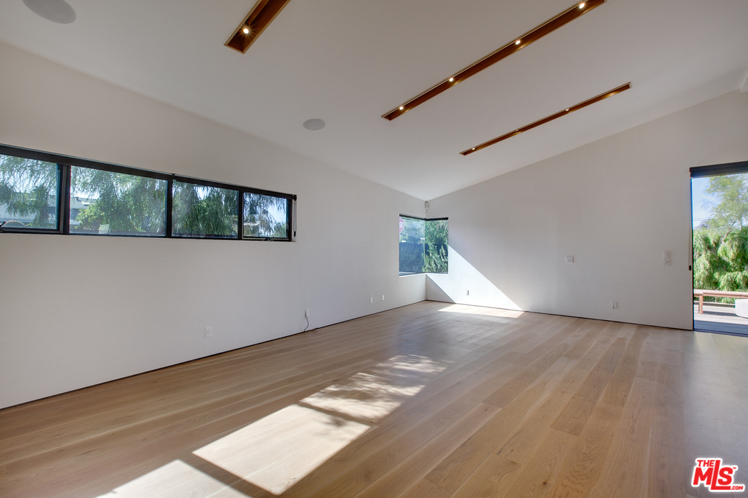 800 7th Avenue Venice, CA 90291 - Photo 6 of 28 a view of an empty room with wooden floor and a window