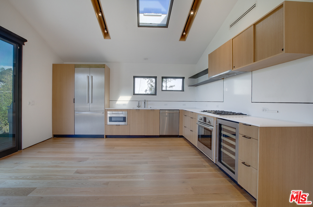 800 7th Avenue Venice, CA 90291 - Photo 8 of 28 a kitchen with stainless steel appliances a stove and a refrigerator