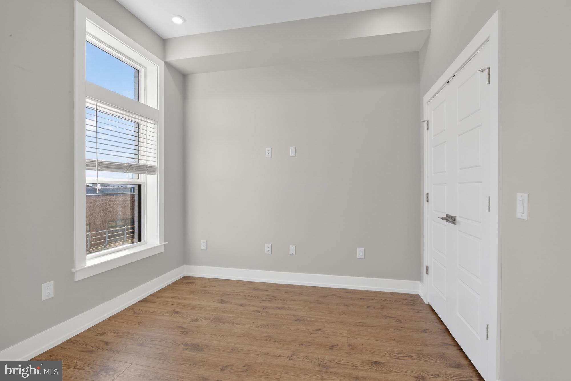 2034 North Front Street, Unit 3 Philadelphia, PA 19122 - Photo 12 of 29 a view of an empty room with wooden floor and a window