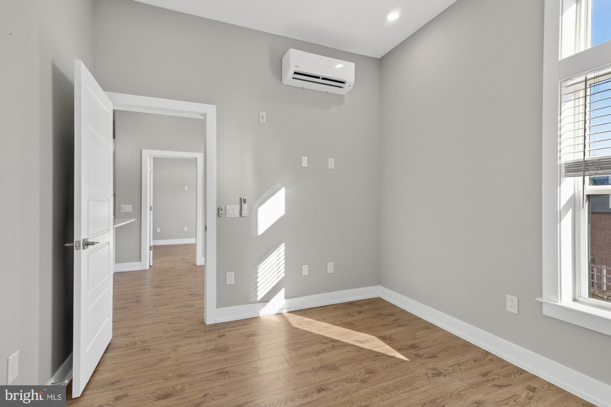 2034 North Front Street, Unit 3 Philadelphia, PA 19122 - Photo 13 of 29 wooden floor in an empty room with a window
