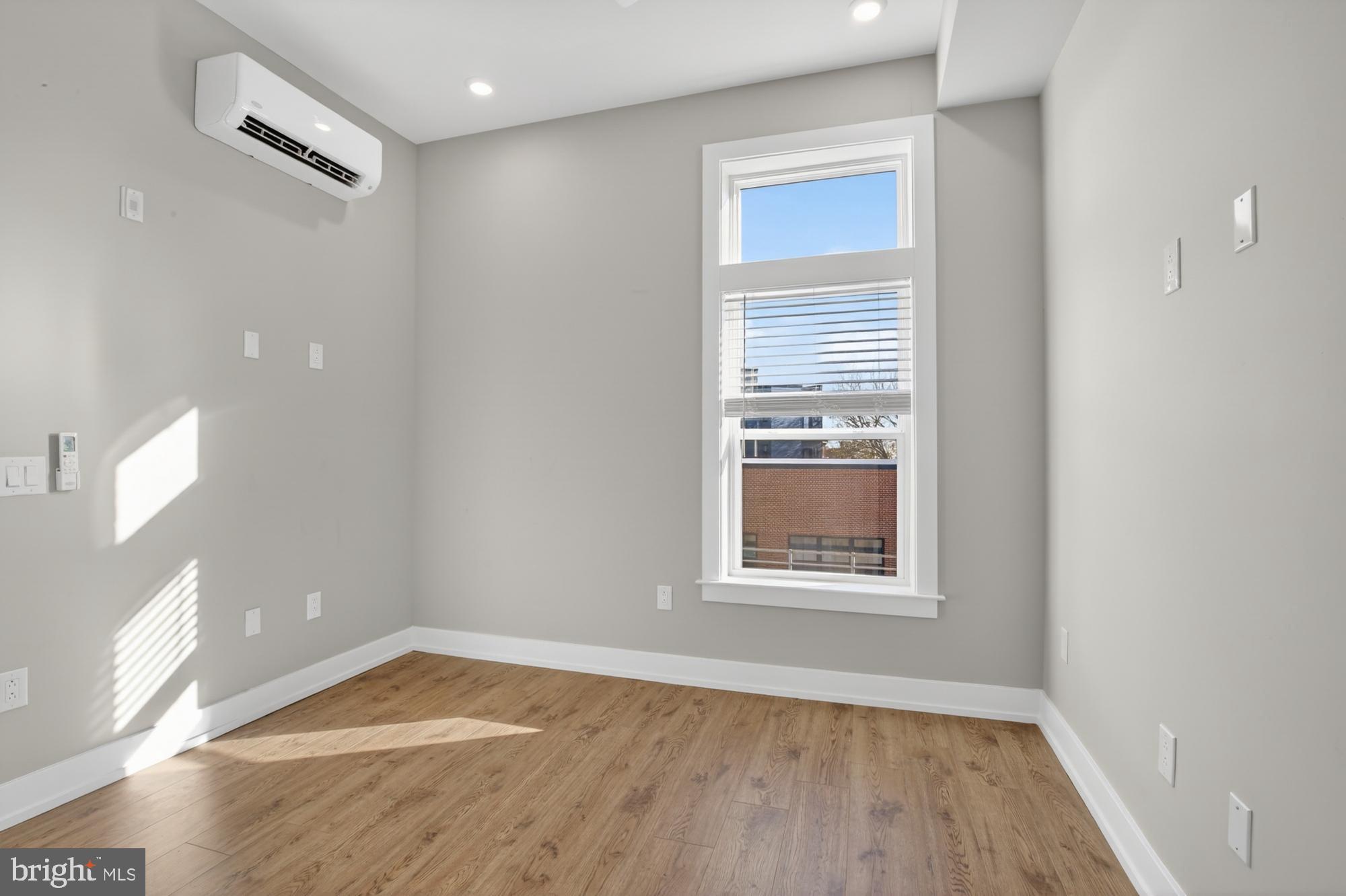 2034 North Front Street, Unit 3 Philadelphia, PA 19122 - Photo 14 of 29 a view of an empty room with wooden floor and a window