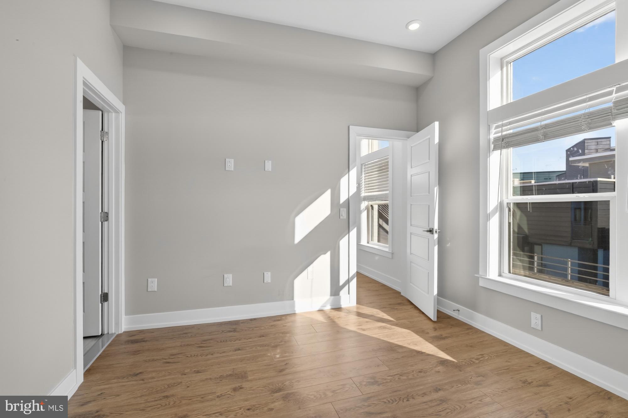 2034 North Front Street, Unit 3 Philadelphia, PA 19122 - Photo 15 of 29 a view of an empty room with wooden floor and a window