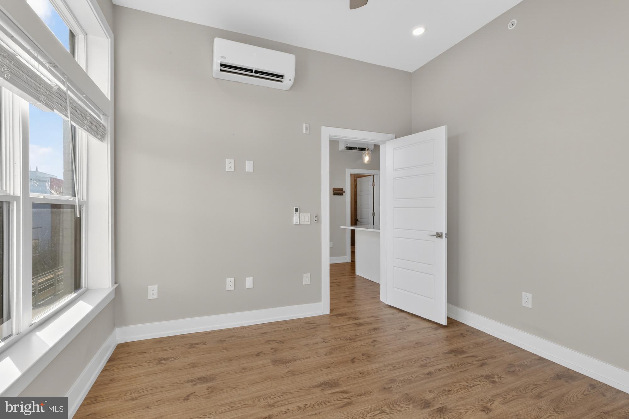 2034 North Front Street, Unit 3 Philadelphia, PA 19122 - Photo 17 of 29 a view of an empty room with wooden floor and a window