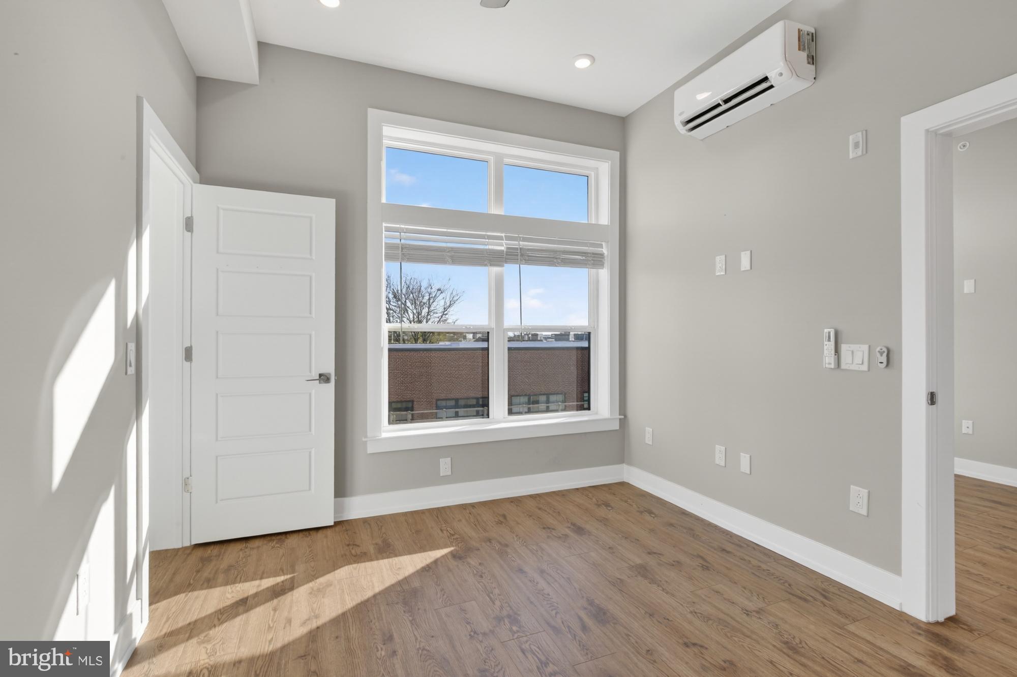 2034 North Front Street, Unit 3 Philadelphia, PA 19122 - Photo 18 of 29 a view of an empty room with wooden floor and a window