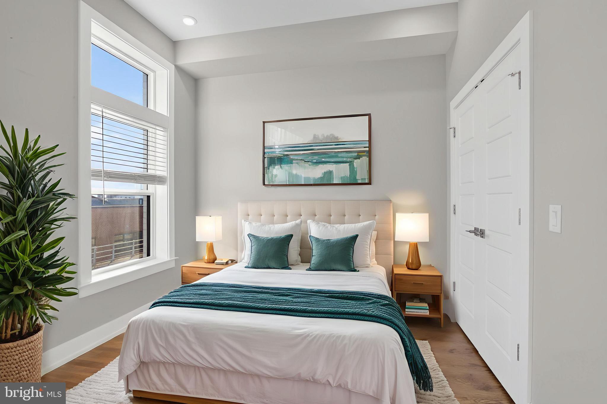 2034 North Front Street, Unit 3 Philadelphia, PA 19122 - Photo 2 of 29 a bedroom with a bed and a potted plant