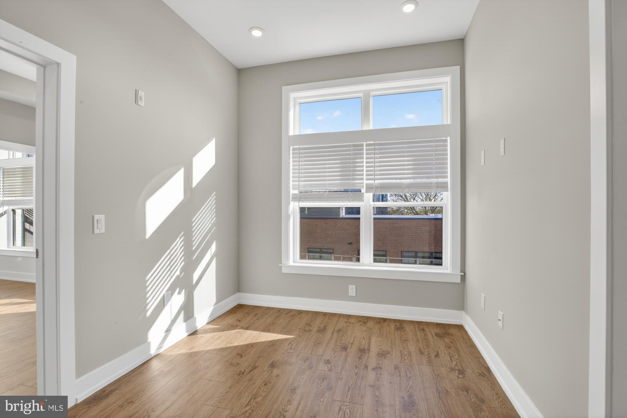 2034 North Front Street, Unit 3 Philadelphia, PA 19122 - Photo 5 of 29 a view of an empty room with wooden floor and a window