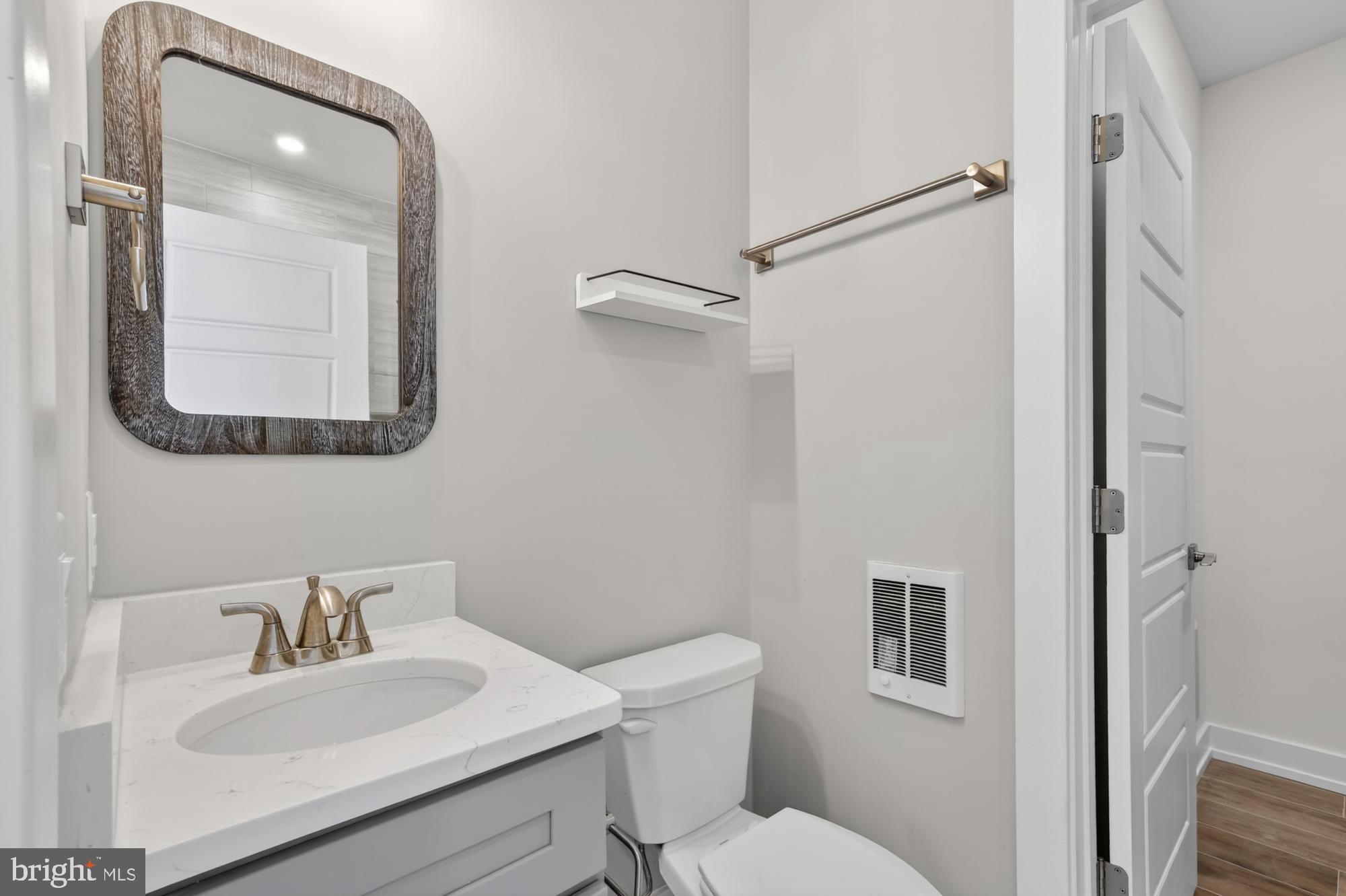 2034 North Front Street, Unit 3 Philadelphia, PA 19122 - Photo 9 of 29 a bathroom with a toilet a sink and mirror