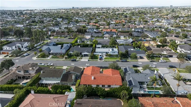 an aerial view of residential houses with outdoor space and lake view