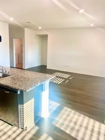 a view of kitchen and empty room